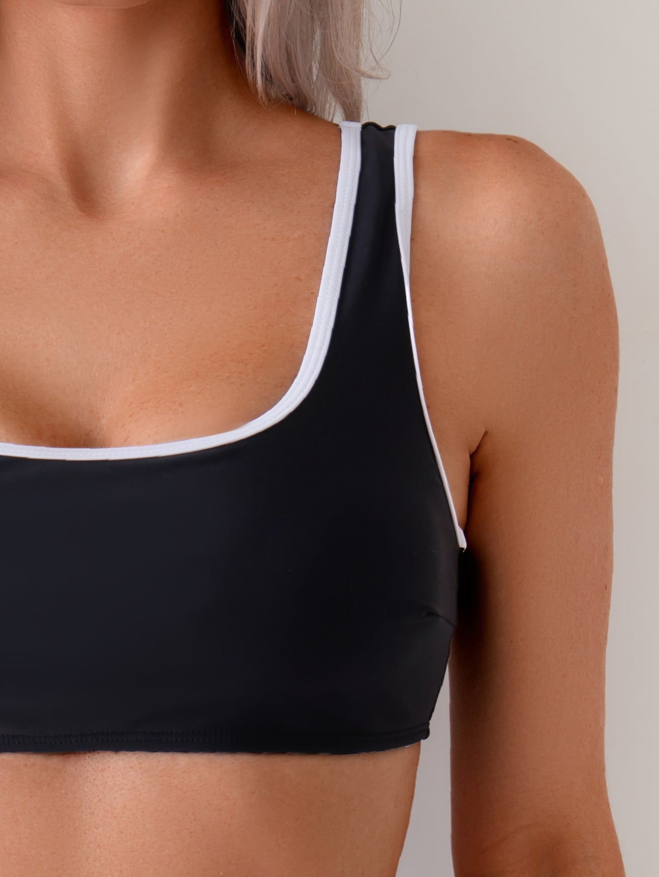 Classic Black Two-Piece Swimsuit with White Trim and High-Cut Bottom