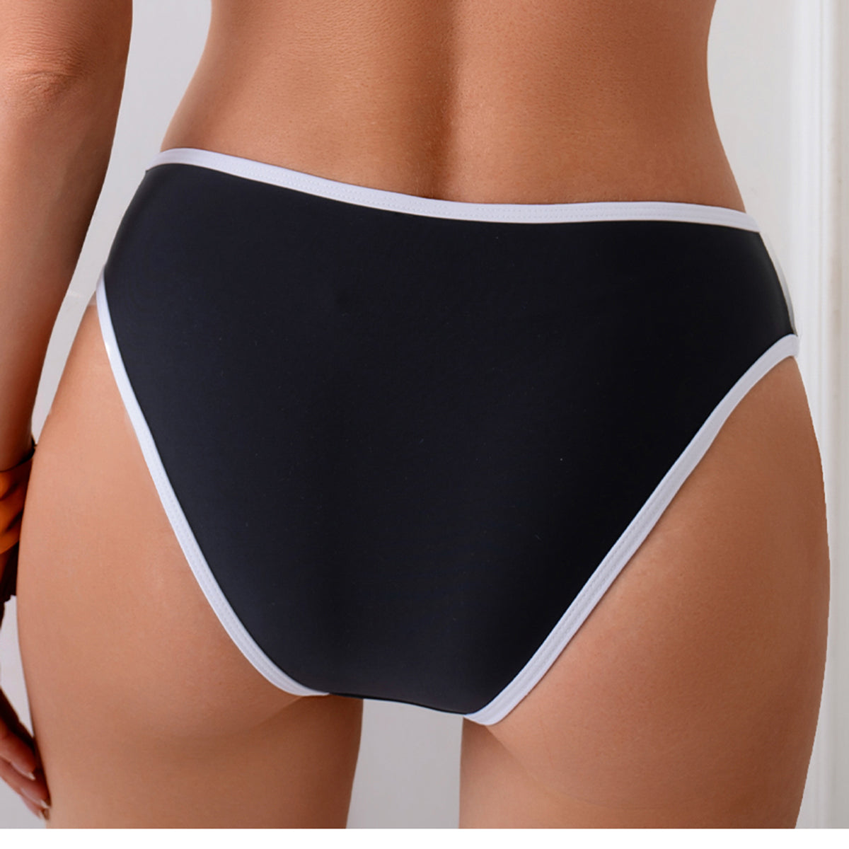 Classic Black Two-Piece Swimsuit with White Trim and High-Cut Bottom